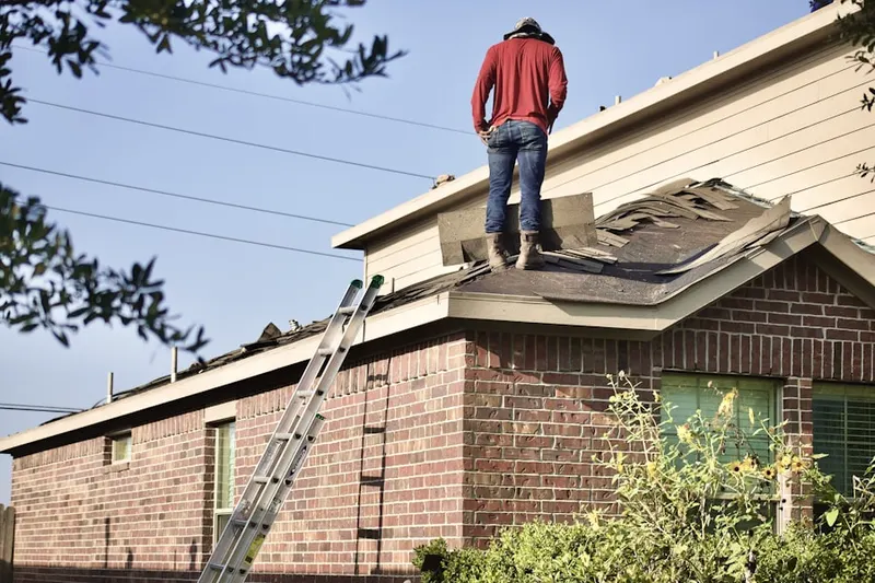 Professional roofer working on a residential roof in Sardis Shores